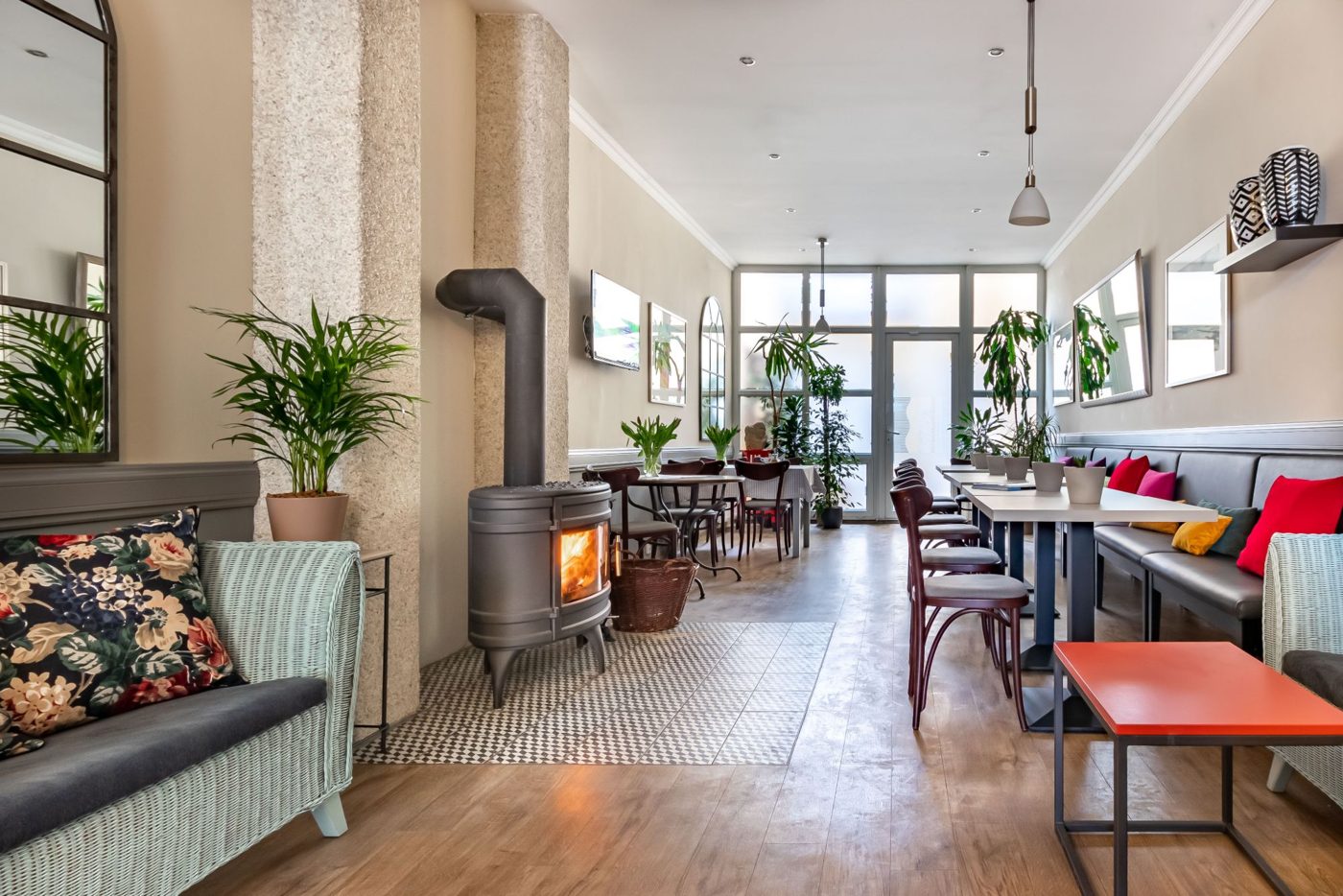 Sofa by the fireplace in the lobby of Hotel SwissHouse